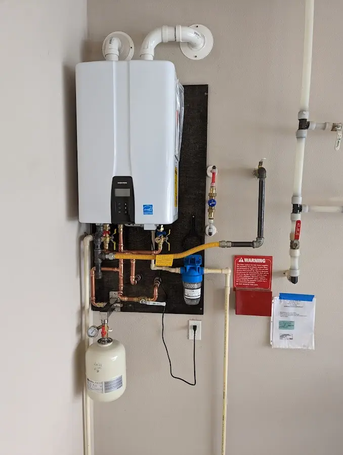 Professional plumber installing copper piping in a Dell Rapids home
